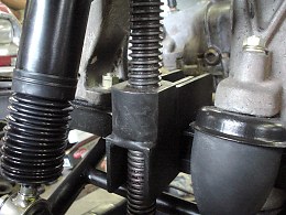 Suspension with special tool to raise spring
